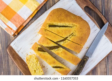 Top View Of Fresh Baked Cut Hatch Chili Pepper Cornbread On A Cutting Board.