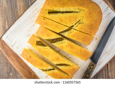 Top View Of Fresh Baked Cut Hatch Chili Pepper Cornbread On A Cutting Board.