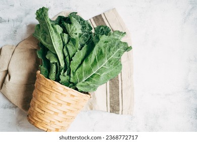 Top view fresh Collard Green in a wicker basket on a white background.copy space. super food. healthy food vegetarian concept. - Shutterstock ID 2368772717
