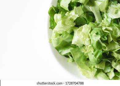 Top View Of Fresh Cut Lettuce On A Plate On A White Background.