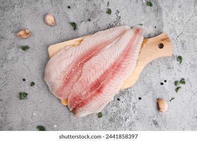 Top view of fresh fillet dory fish on wooden tray