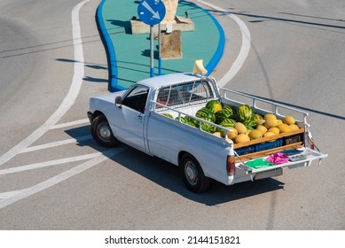 Top View Of Fresh Fruit In White Pick Up Truck. Ripe Watermelons And Melons. A Mobile Trader Or Dealer Selling Fruit From Back Of A Vehicle On Street In Fishing Village, Greece.