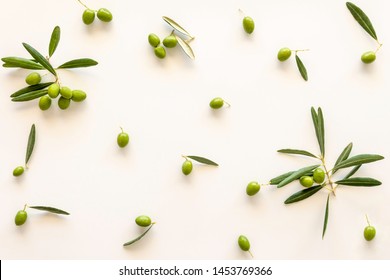 Top View Of Fresh Green Olive Fruit With Leaves On White Background.