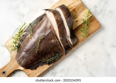 Top View Of Fresh Halibut On Wooden Board With Herbs. Rich Of Healthy Omega 3 Unsaturated Fats Good For Mental Clarity. Brain Food