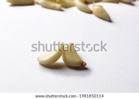Top view fresh peeled garlic cloves, bulb with garlic slices isolated on white background.