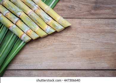 Top View Fresh Sugar Cane And Leaf On Wooden Background