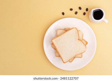 Top view of Fresh toast white bread slice in white plate on beige background. vegan product, Minimalist concept - Powered by Shutterstock