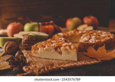 Top view of a freshly baked apple pie surrounded by fresh apples, wooden spoons, a lit candle, and cozy autumn elements on a warm-toned background. Perfect for fall and Thanksgiving themes. - Powered by Shutterstock