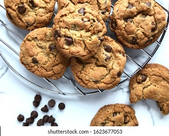 Top view of freshly baked chocolate chip cookies on a wire cooling rack - Powered by Shutterstock