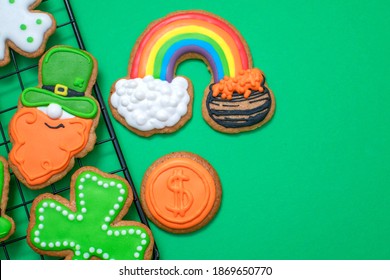 Top View Of Freshly Baked St. Patricks Day Decorated Sugar Cookies On The Oven Tray Background. Homemade Cookies With Shamrock, Rainbow, Leprechaun And Pot Of Gold Decorations. Irish Holiday