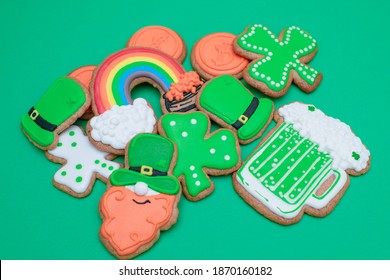 Top View Of Freshly Baked St. Patricks Day Decorated Sugar Cookies On Green Background. Homemade Cookies With Shamrock, Rainbow, Leprechaun With Beer And Pot Of Gold Decorations. Irish Holiday