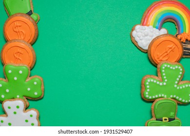 Top View Of Freshly Baked St. Patricks Day Decorated Sugar Cookies On Green Background. Homemade Cookies With Shamrock, Rainbow, Leprechaun And Pot Of Gold Decorations. Irish Holiday