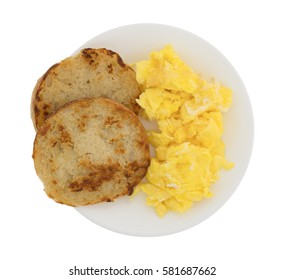 Top View Of A Freshly Fried English Muffin With Scrambled Eggs On A Plate Isolated On A White Background.