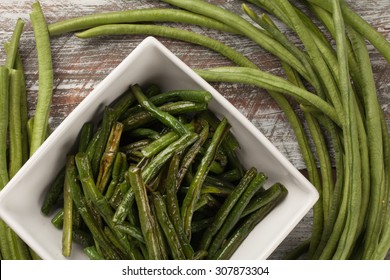 Top View Of Freshly Harvested Asian Green Beans On A Weathered Barn Wood Table With A Bowl Of Cooked Beans