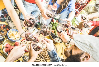 Top View Of Friend Hands Toasting Red Wine Glass And Having Fun Outdoor Cheering At Picnic Winetasting - Young People Enjoying Summer Time Together At Lunch Bbq Garden Party - Youth Friendship Concept