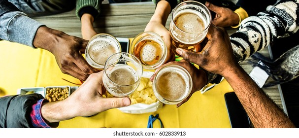 Top View Of Friends Cheering With Home Brew In Pub Bar Restaurant - Young People Hands Toasting And Beers Half Pint - Party Concept - Warm Filter - Focus On Bottom Hands Glasses