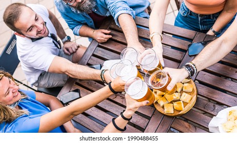 Top View Of Friends Toasting With Beer At Pub. Return To Normal Life