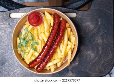 Top view. Fries, fried sausages, sauce. Take away fast food - Shutterstock ID 2217578377