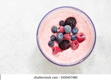 Top View Of Frozen Berries In Smoothie In Blender Bowl Copy Space