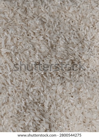 Top view full frame macro texture background of raw unbaked white rice grains