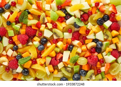 Top view of full frame textured background of assorted chopped fruits and berries prepared for healthy breakfast - Powered by Shutterstock