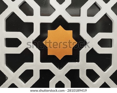 Top view full frame of white Islamic geometric fretwork pattern with center gold star accent