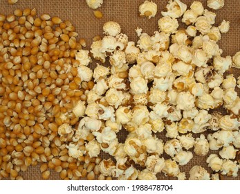 Top view of a  full of freshly popped popcorn with  and unpopped kernels the side.
