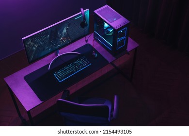 Top view of gamer work space and professional gaming setup: mouse, keyboard, monitor, headset, powerful computer. Premium PC with RGB light inside. Cyber sportsman empty studio with streaming setup - Shutterstock ID 2154493105