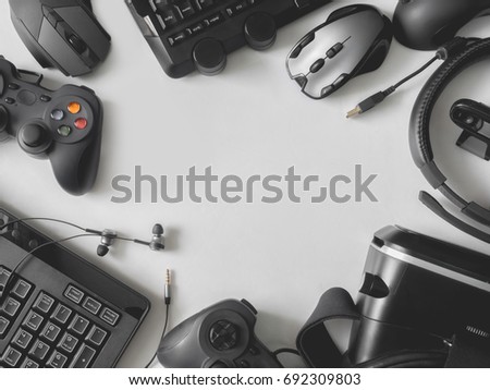 top view of gaming gear, gaming space concept, with mouse, keyboard, headset, joystick, webcam, VR Headset on white background with copy space.