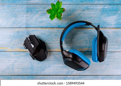 Top View A Gaming Gear Streaming Games Headset And Mouse On Old Wood Table Background.