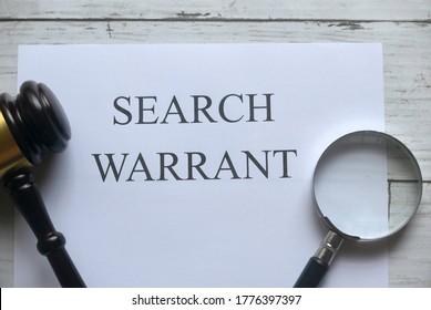 Top View Of Gavel,magnifying Glass And Paper Written With Search Warrant On White Wooden Background.