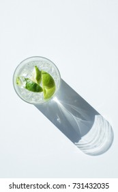 Top View Of Gin Tonic Cocktail In Glass With Shadow On White 