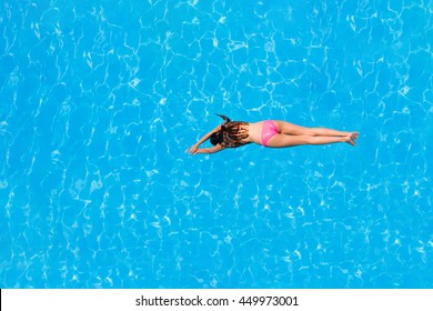 Top View Of A Girl Diving In The Swimming Pool