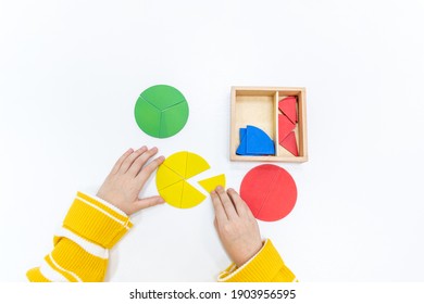 Top view of girls hand is playing and sorting a puzzle of colored wooden geometric shapes in montessori school. Concept of using a mathematical geometry learning resources for children education. - Shutterstock ID 1903956595
