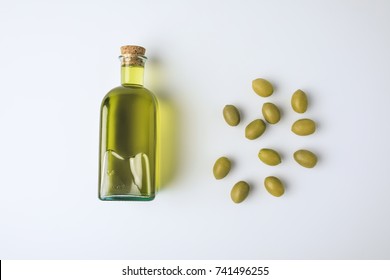 Top View Of Glass Bottle With Olive Oil And Green Olives Isolated On White 