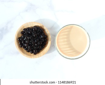 Top View Of A Glass Cup Of Pearl Milk Tea (also Called Bubble Tea) And A Plate Of Tapioca Ball. Pearl Milk Tea Is The Most Representative Drink In Taiwan. Taiwan Food . With Copy Space.