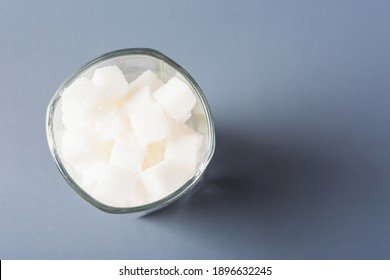 Top View Glass Full Of White Sugar Cube Sweet Food Ingredient, Studio Shot Isolated On Gray Background, Health High Blood Risk Of Diabetes And Calorie Intake Concept And Unhealthy Drink