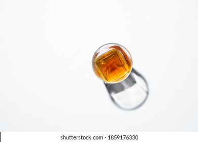 Top view of glass whiskey on white background