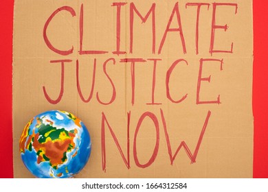 Top View Of Globe And Placard With Climate Justice Now Lettering On Red Background, Global Warming Concept