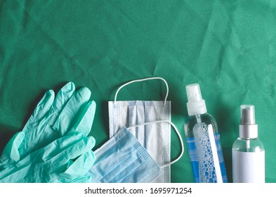 Top View Of Gloves, Medical Mask, Bottles Of Hands Sanitizer On The Operating Table.Empty Space