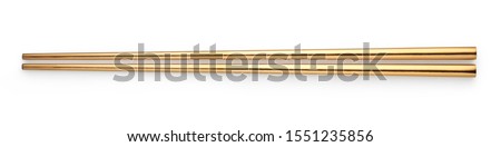 Top view of Golden chopsticks isolated on white background
