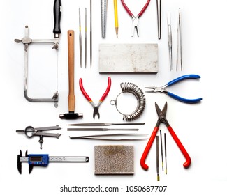 Top View Of Goldsmiths Tools, Jewelry Objects. Tools Over White Background.