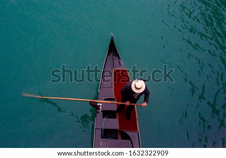 Top view of gondolier sailing on canal