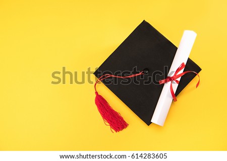 Top view of graduation mortarboard and diploma isolated on yellow background, education concept