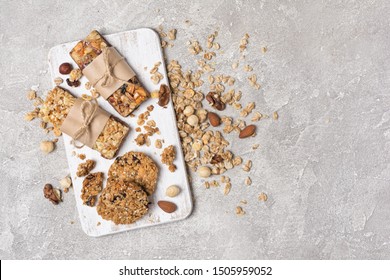 Top view of granola energy bar with mix of nuts for healthy nutrition on gray concrete background with copy space - Shutterstock ID 1505959052
