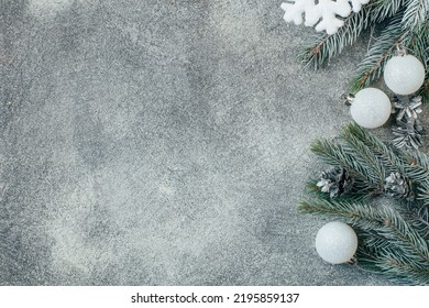 Top View Of A Gray Concrete Background Christmas Decorated With Branches Of A Christmas Tree With Christmas Decorations Pine Cones With Free Space For Text