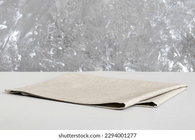 top view with gray kitchen napkin isolated on table background. Folded cloth for mockup with copy space, Flat lay. Minimal style. - Shutterstock ID 2294001277