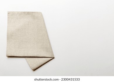 top view with gray kitchen napkin isolated on table background. Folded cloth for mockup with copy space, Flat lay. Minimal style.
