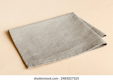 top view with gray kitchen napkin isolated on table background. Folded cloth for mockup with copy space, Flat lay. Minimal style.