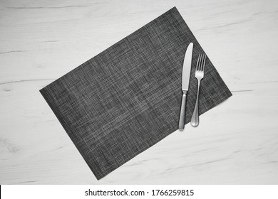 Top View Of Gray Placemat Table Mat With Knife And Fork On White Wooden Table